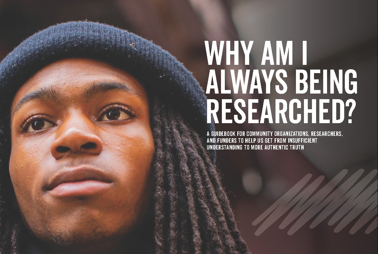 Close-up of a person with long hair wearing a beanie, looking thoughtful. Text reads, WHY AM I ALWAYS BEING RESEARCHED? A guidebook for community organizations, researchers, and funders to help us get from insufficient understandings to more authentic truth.