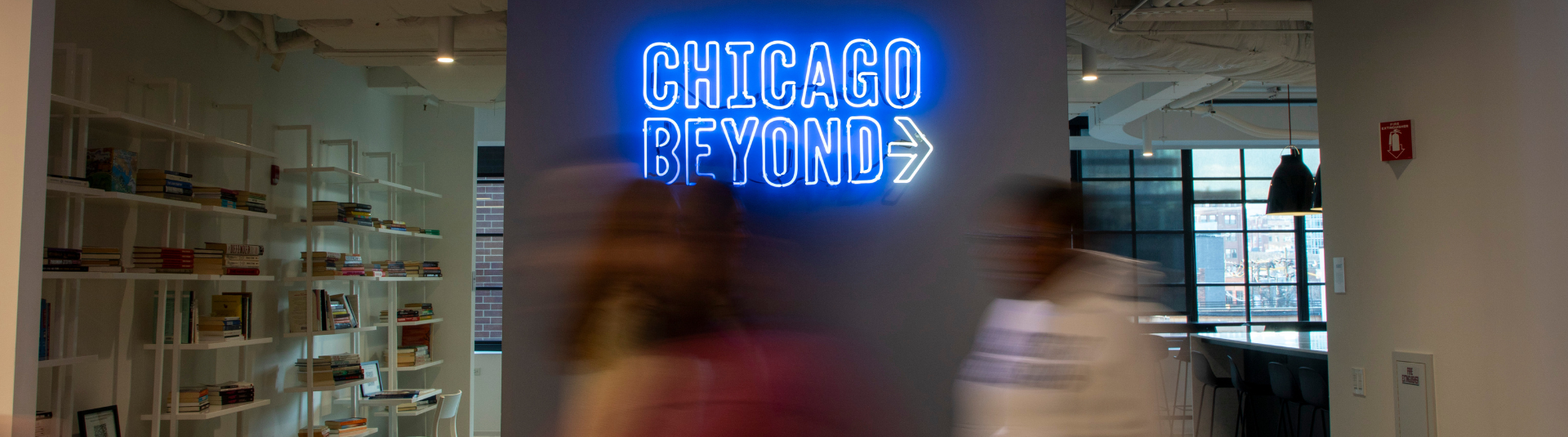 A wide angle photo of Chicago Beyond teammates laughing at the Chicago Beyond headquarters